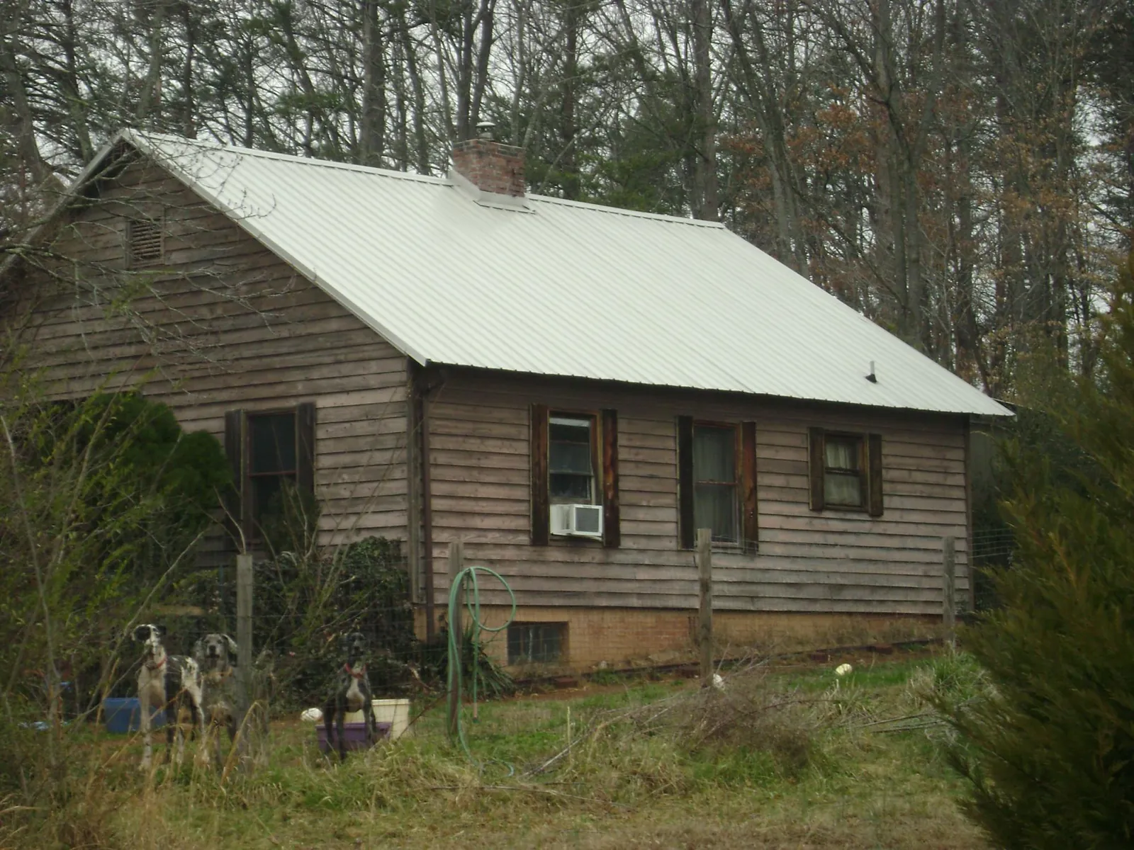 White metal roof on an old wood sided farmhouse, from a Metal Roof Installation job in Sparta